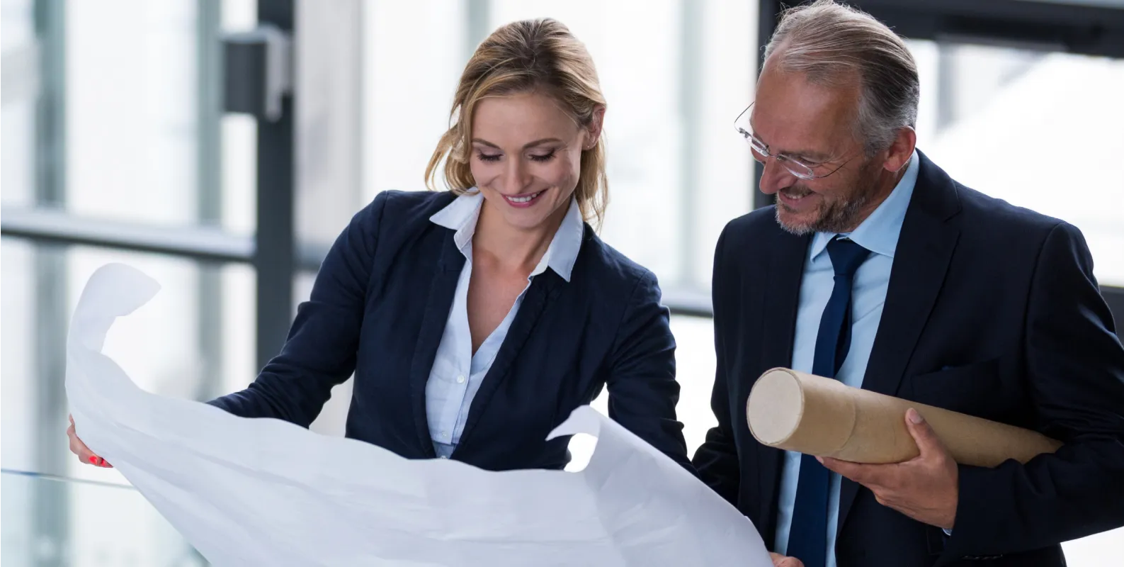 A man and a woman looking at a piece of paper.