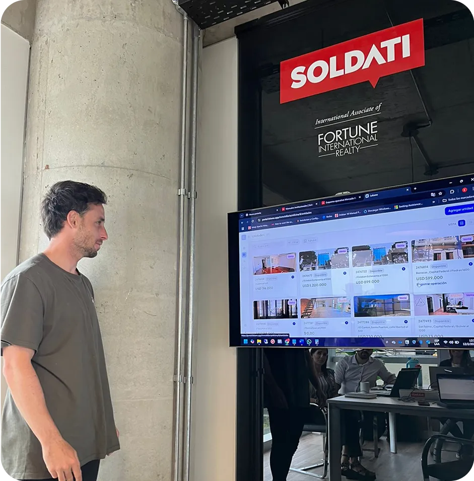 A man standing in front of a flat screen tv.