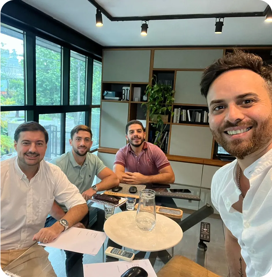 A group of men sitting around a table.