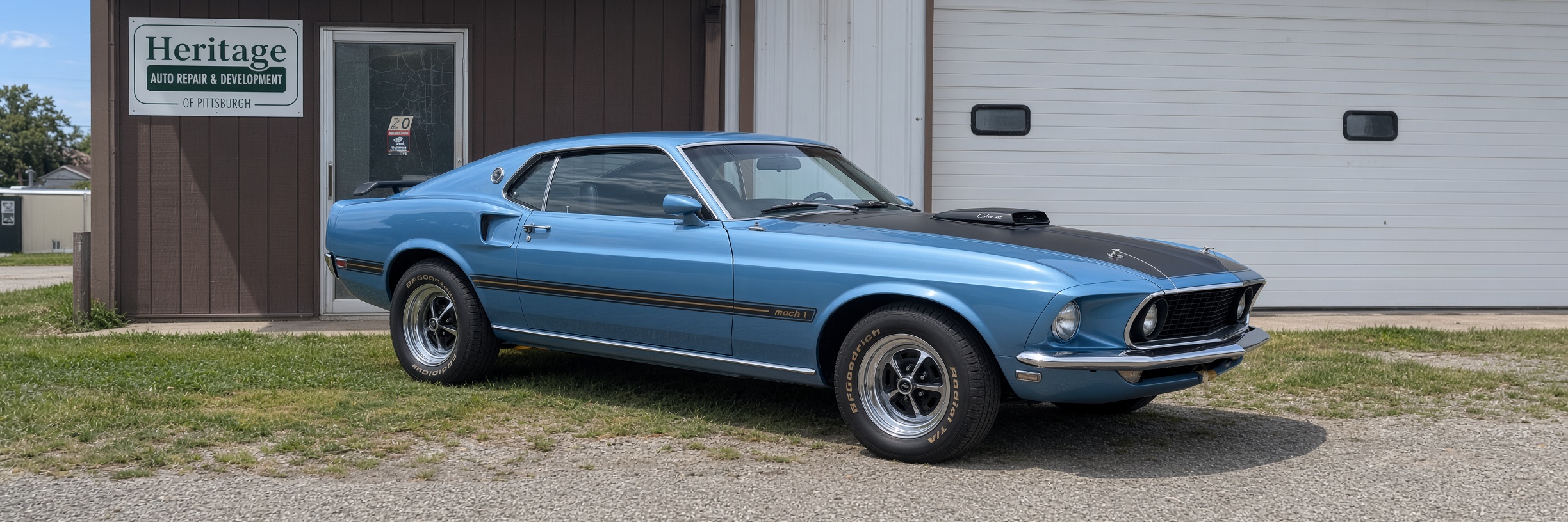 Blue 1969 Mustang parked outside the Heritage Auto Repair & Development shop