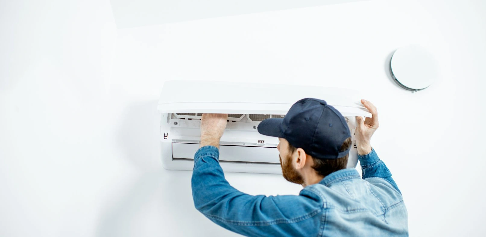 Photo of a man cleaning a split aircon