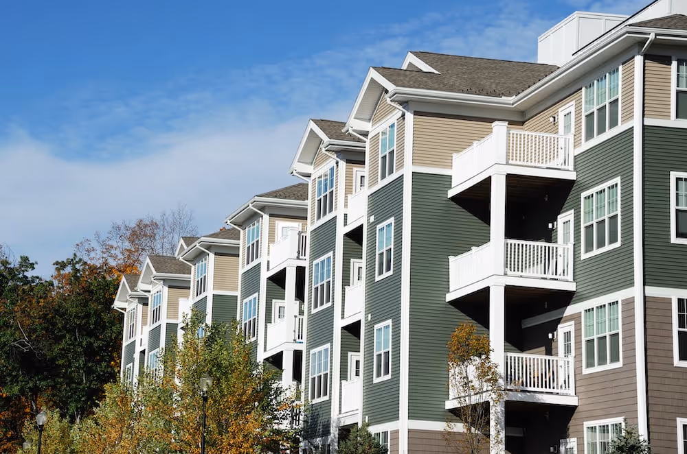 A row of multi - story apartment buildings with balconies and balconies.