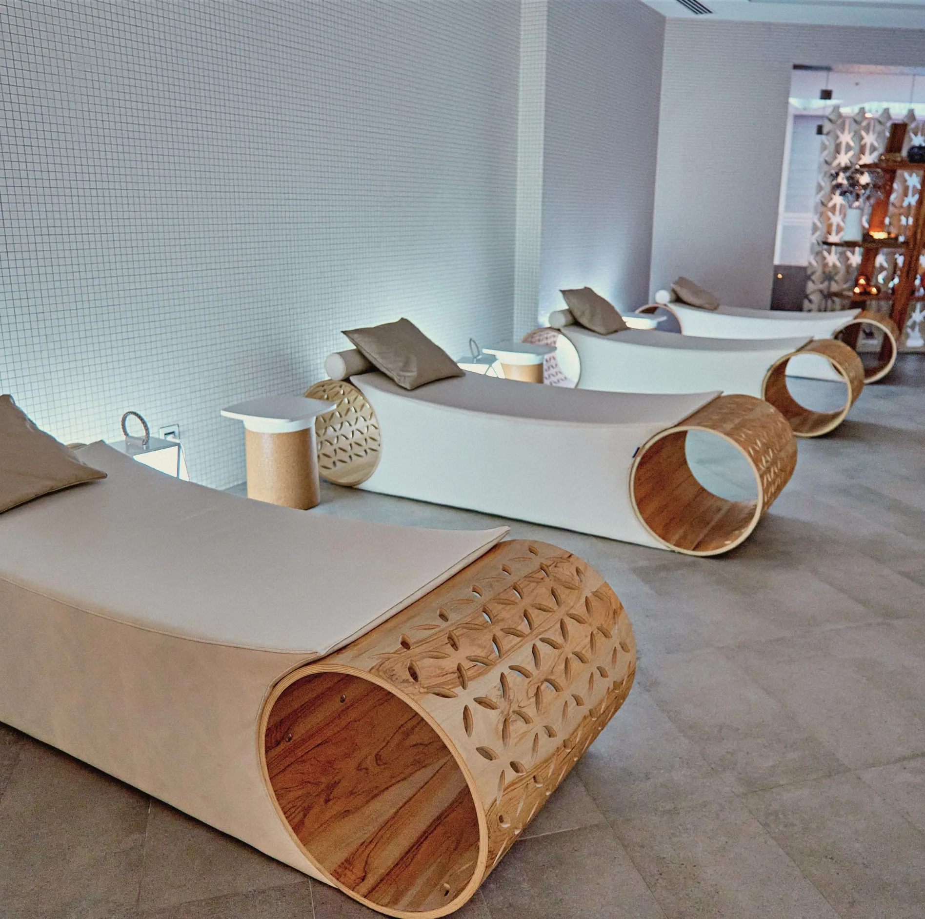 Wooden cylindrical meditation equipment on concrete floor in minimalist wellness room