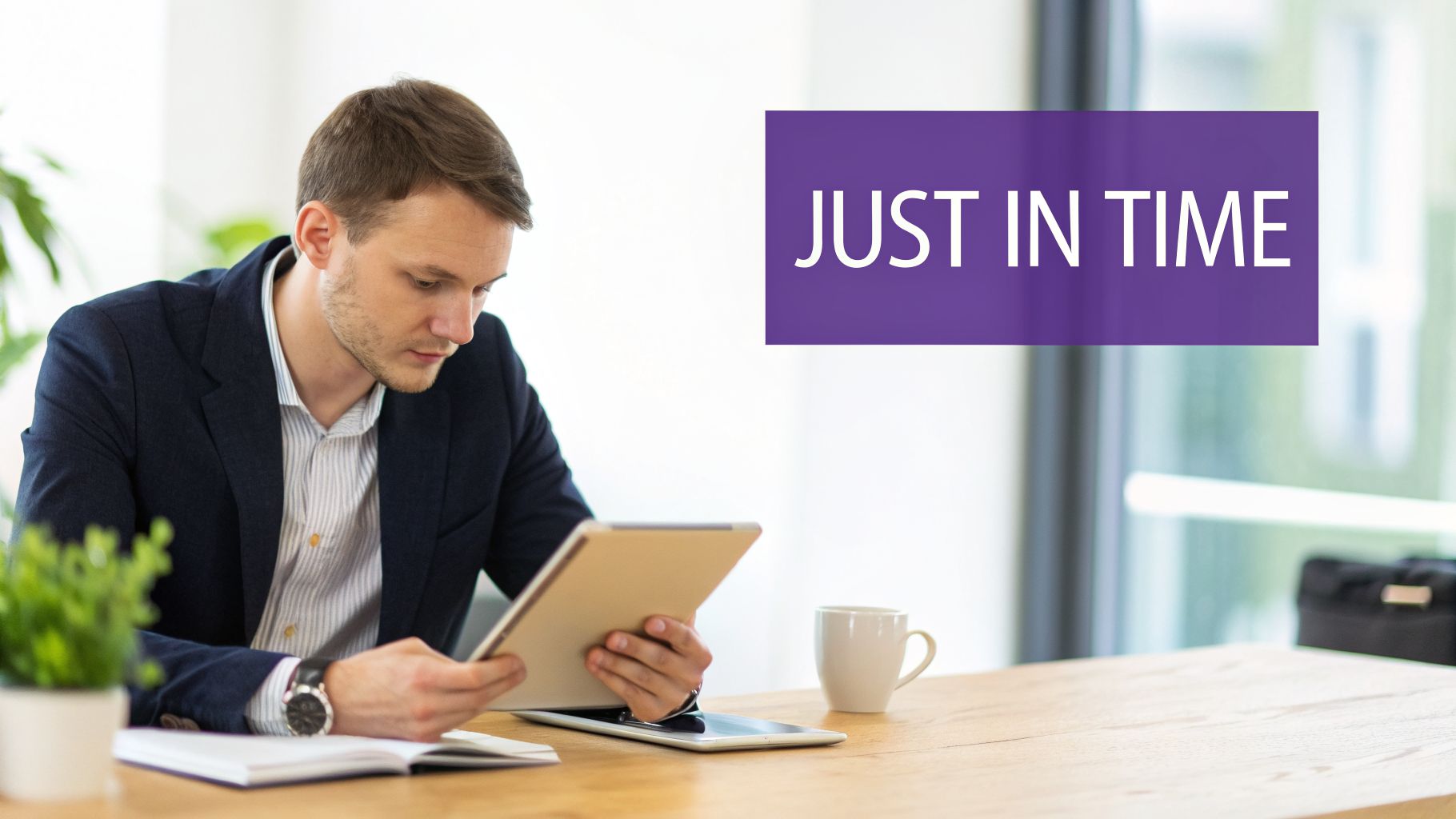 A focused businessman uses a tablet at a desk, with 'JUST IN TIME' text shown.