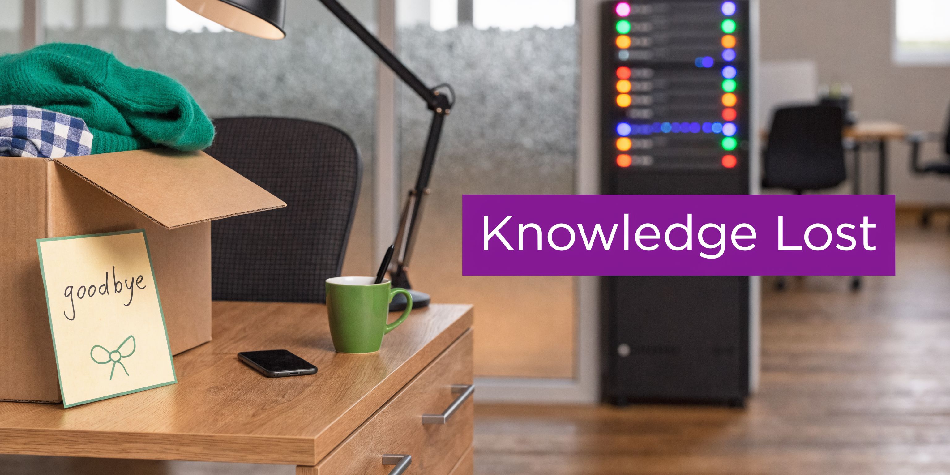 A cardboard box with a goodbye note on an office desk, representing employee turnover and knowledge loss.