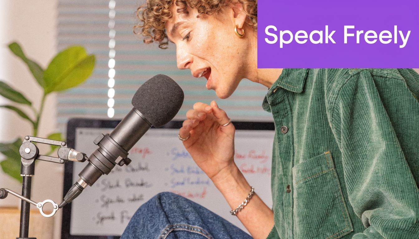 A person with curly hair speaking into a professional microphone during a podcast recording session.