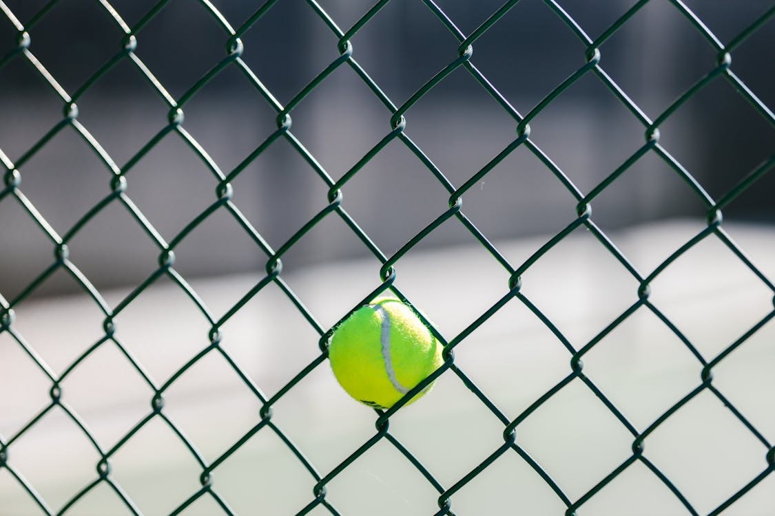 A ball stuck in a fence