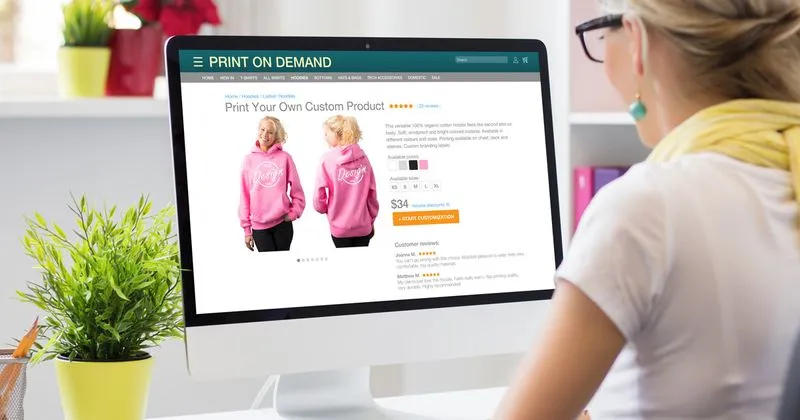 A woman in front of a computer monitor looking at a website.