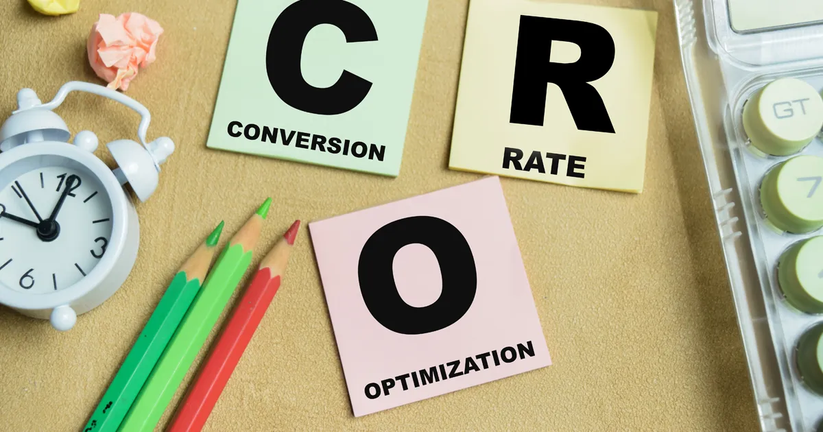 Concept of CRO - Conversion Rate Optimization write on sticky notes isolated on Wooden Table.