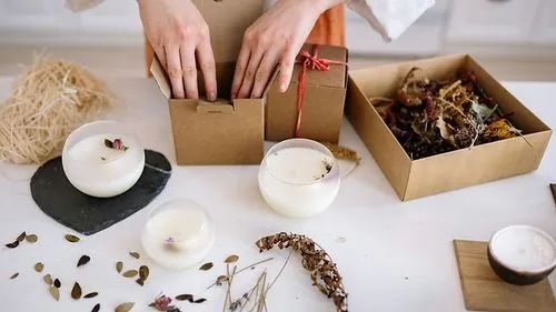 A close-up of a person holding an open cardboard box labeled "Special Delivery" in white text. The box is filled with red crinkle paper, adding a festive touch to the packaging.