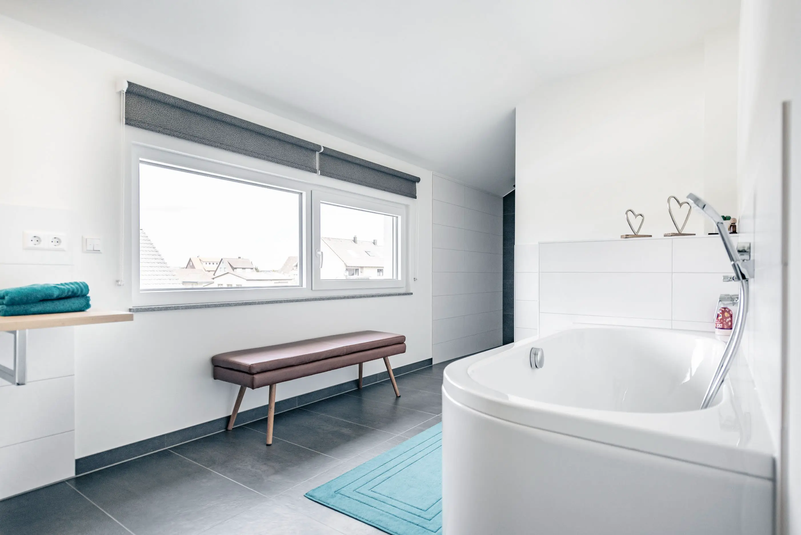 Lichtdurchflutetes Badezimmer mit Badewanne Im Einfamilienhaus des Jubiläumshauses in Vöhringen, gebaut von Hauser Massivbau 