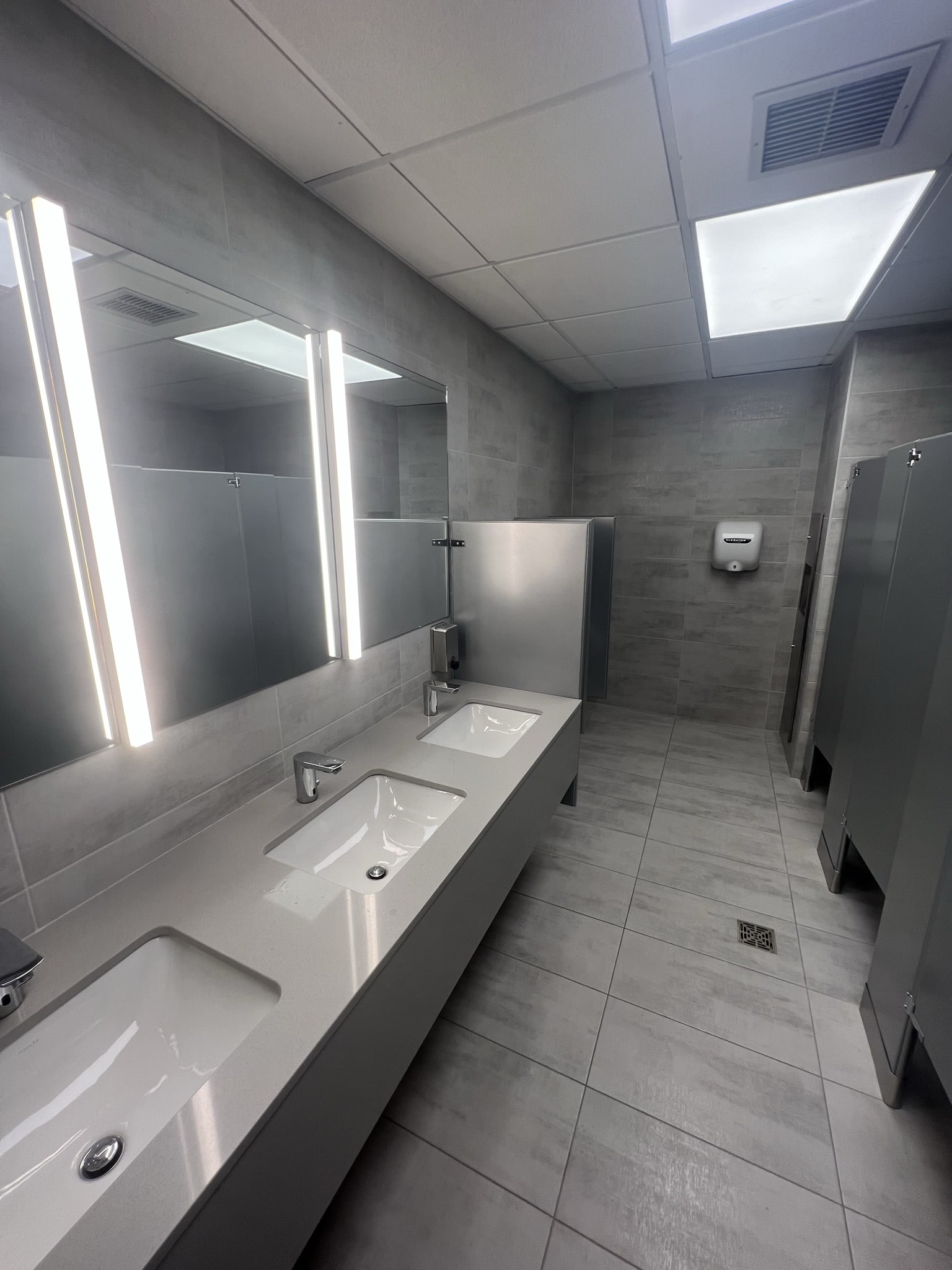 Finished commercial restroom with dual sink vanity