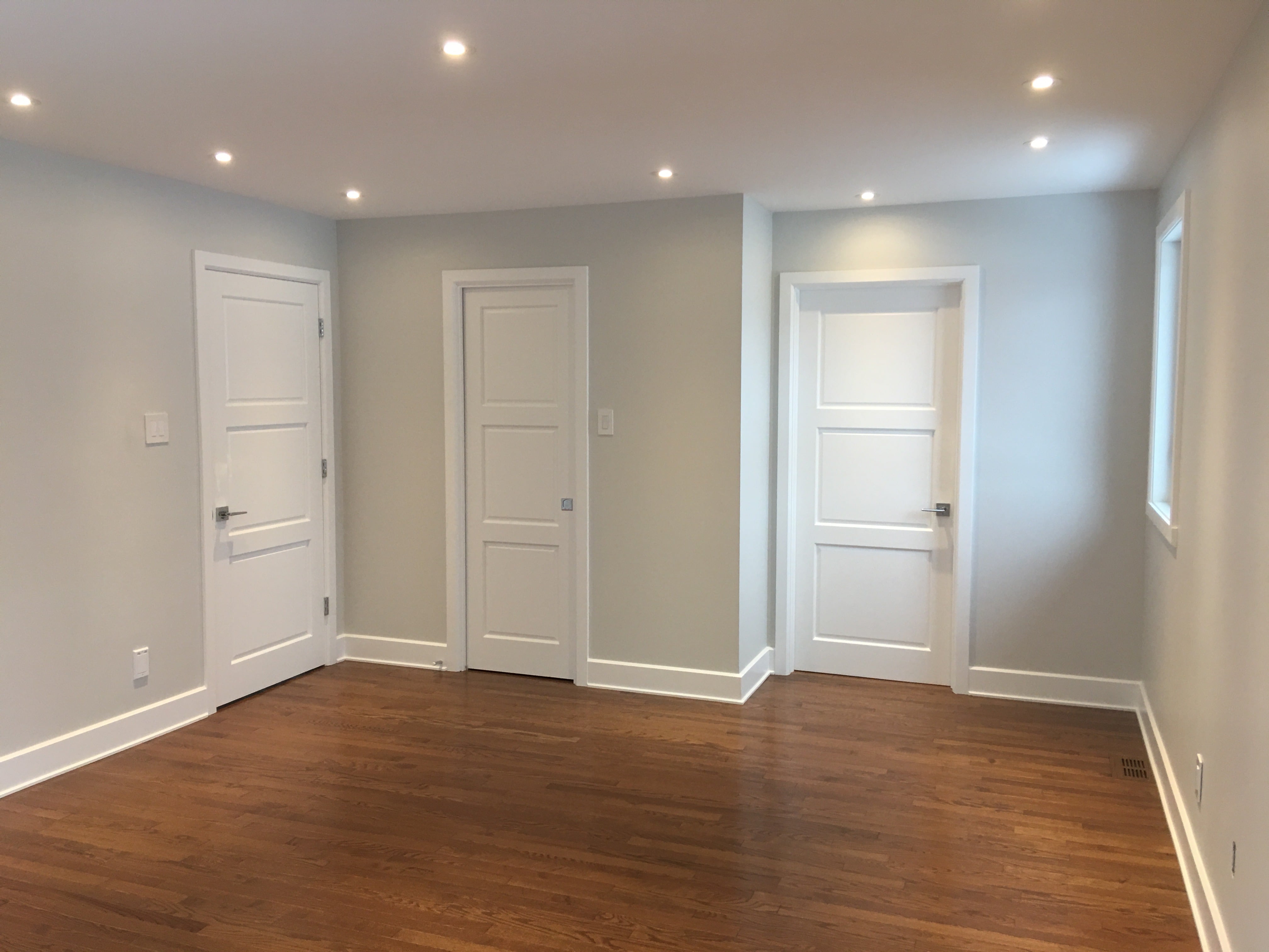 Contemporary living area with open layout and wood floors