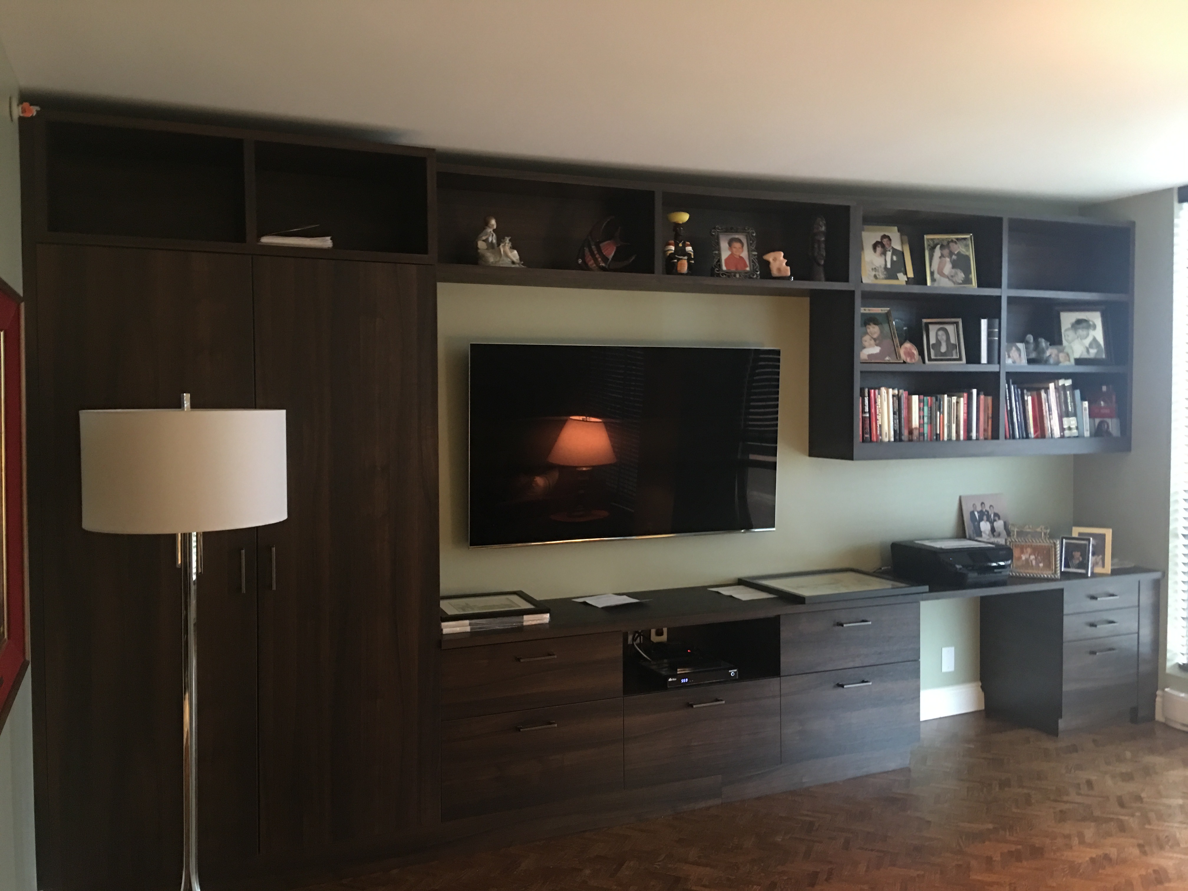 Contemporary living area with open layout and wood floors
