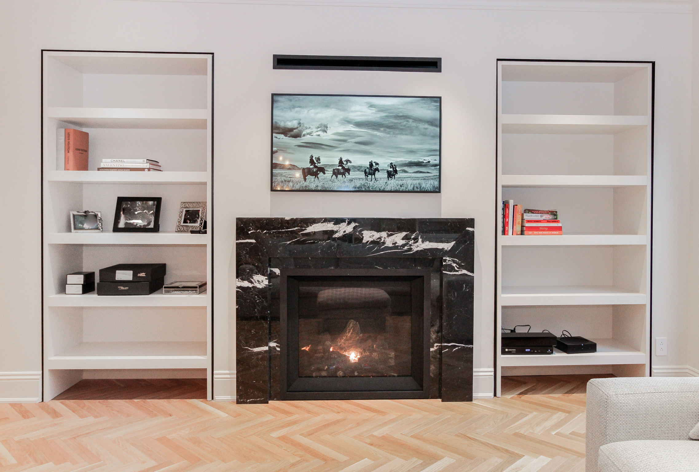 Contemporary living area with open layout and wood floors