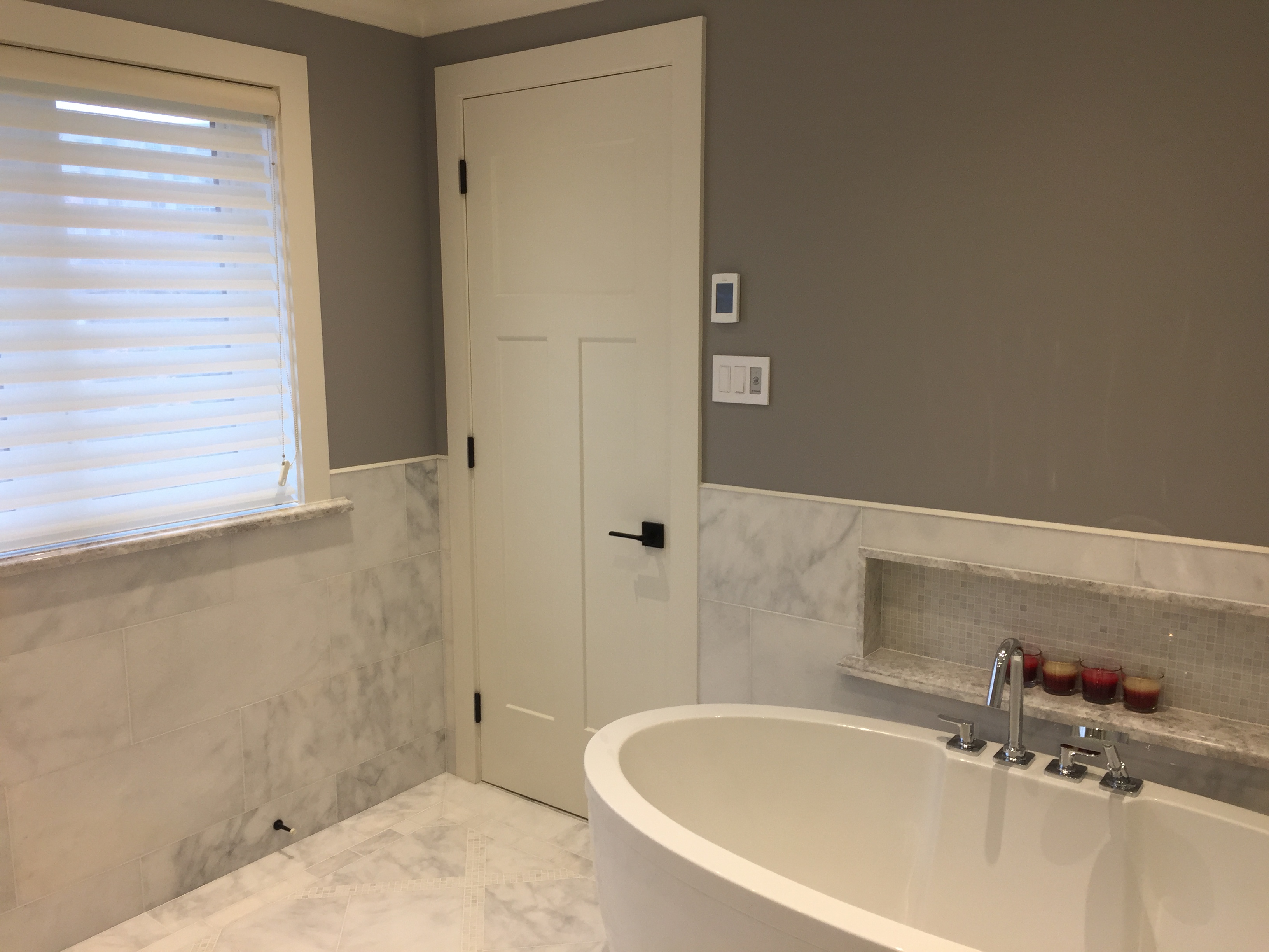 Walk-in shower with frameless glass and rain head