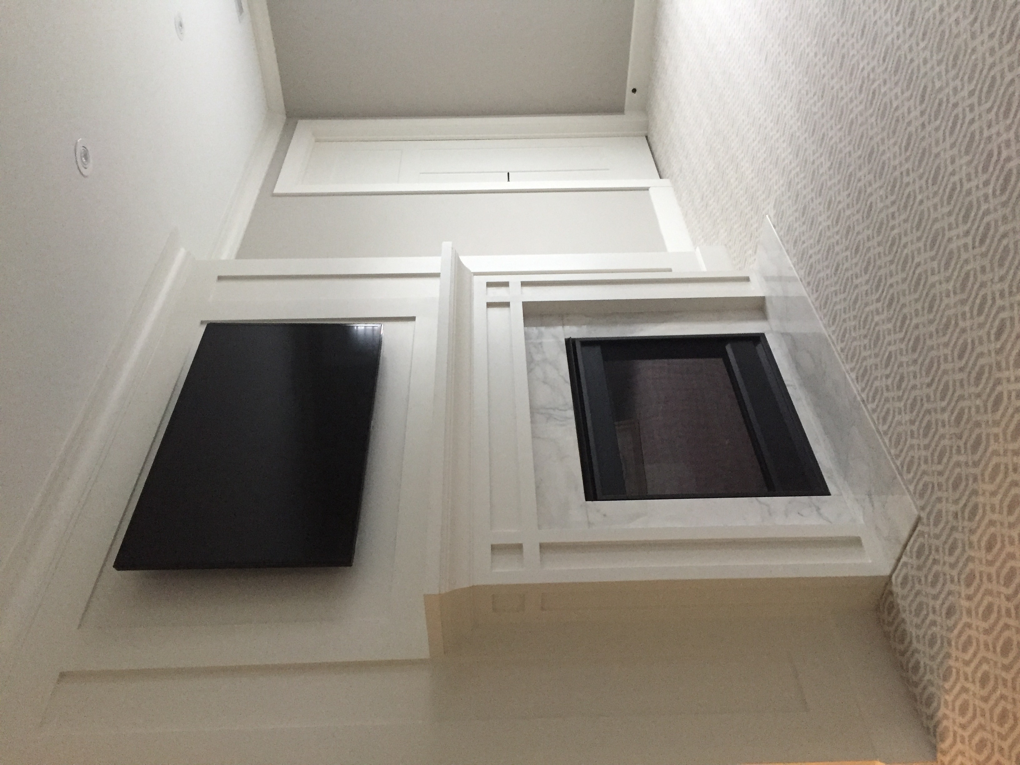 Contemporary living area with open layout and wood floors