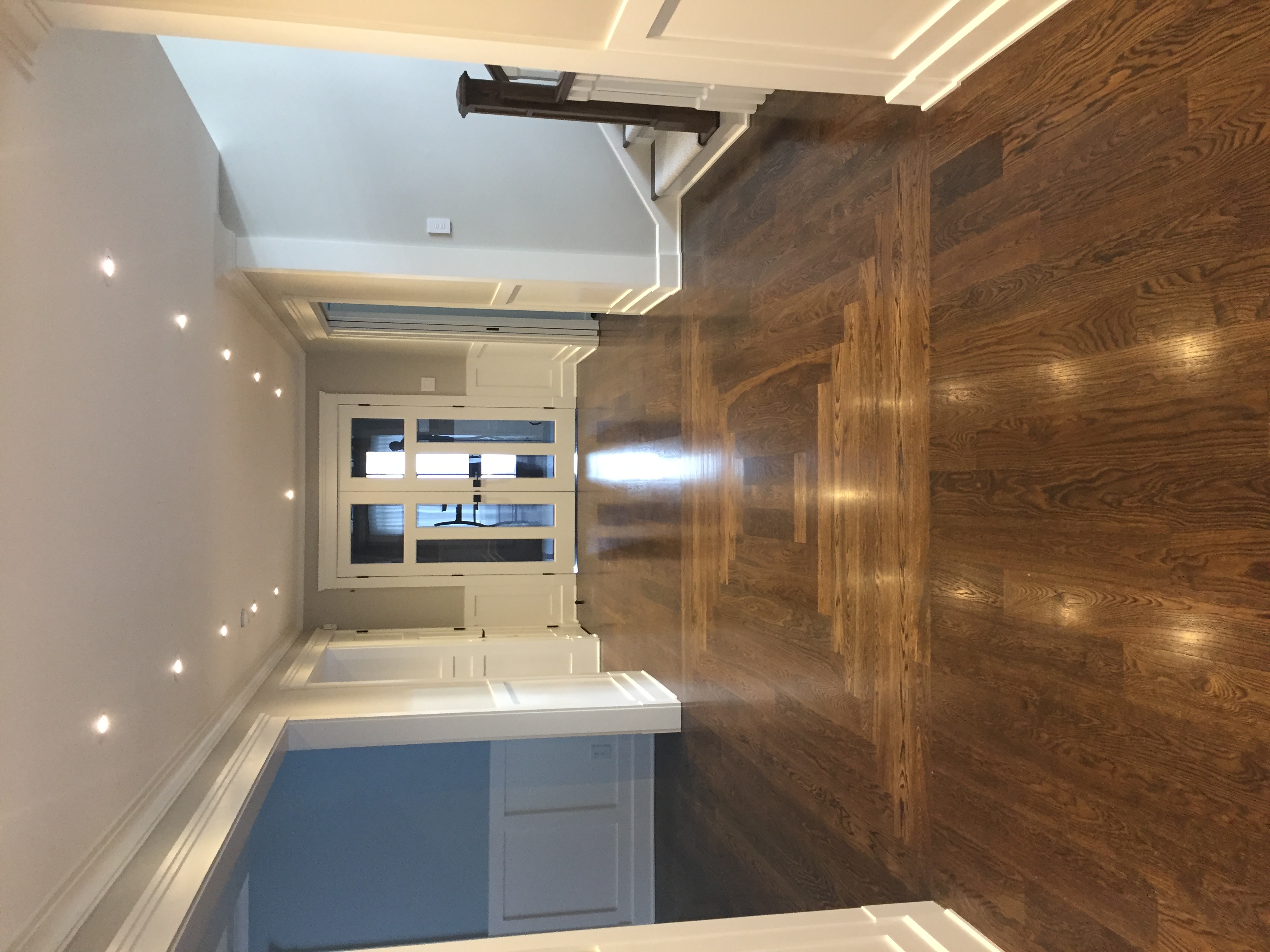 Contemporary living area with open layout and wood floors