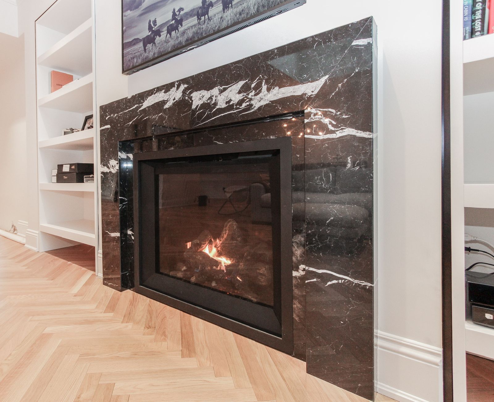 Contemporary living area with open layout and wood floors
