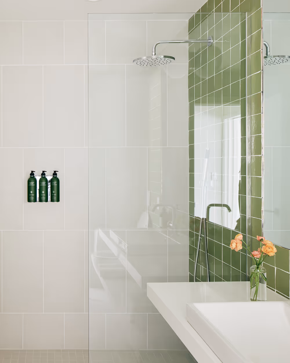 Bathroom with shower and sink, green tile feature wall