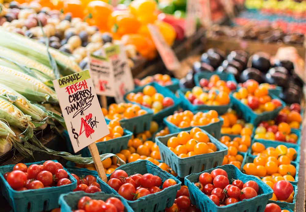 Cartons of tomatoes at a farmers market stand