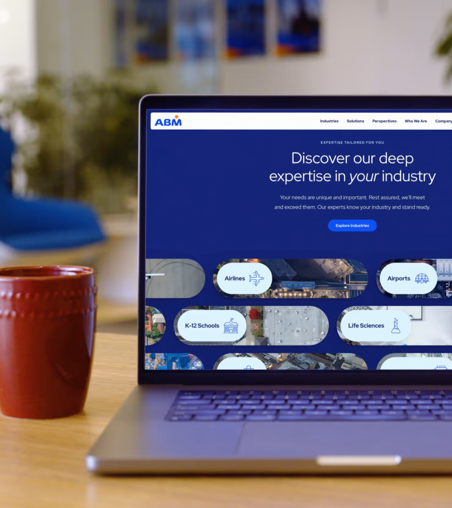 Close-up of a laptop showing the ABM marketing website.