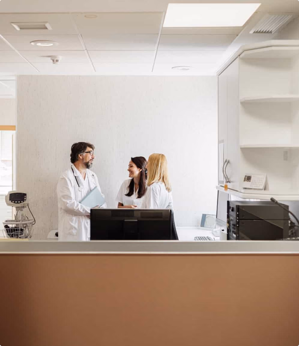 Medical professionals discussing patient care in a bright fertility clinic laboratory.