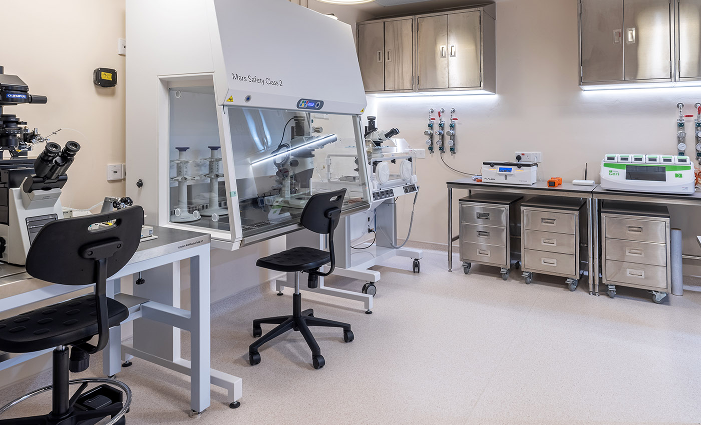 Embryology laboratory equipped with microscopes, enclosed workstations, incubators, gas systems, and specialised fertility lab equipment.