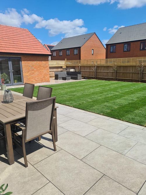 New porcelain patio and freshly laid lawn in a Long Buckby back garden – completed by Link Construction and Landscaping