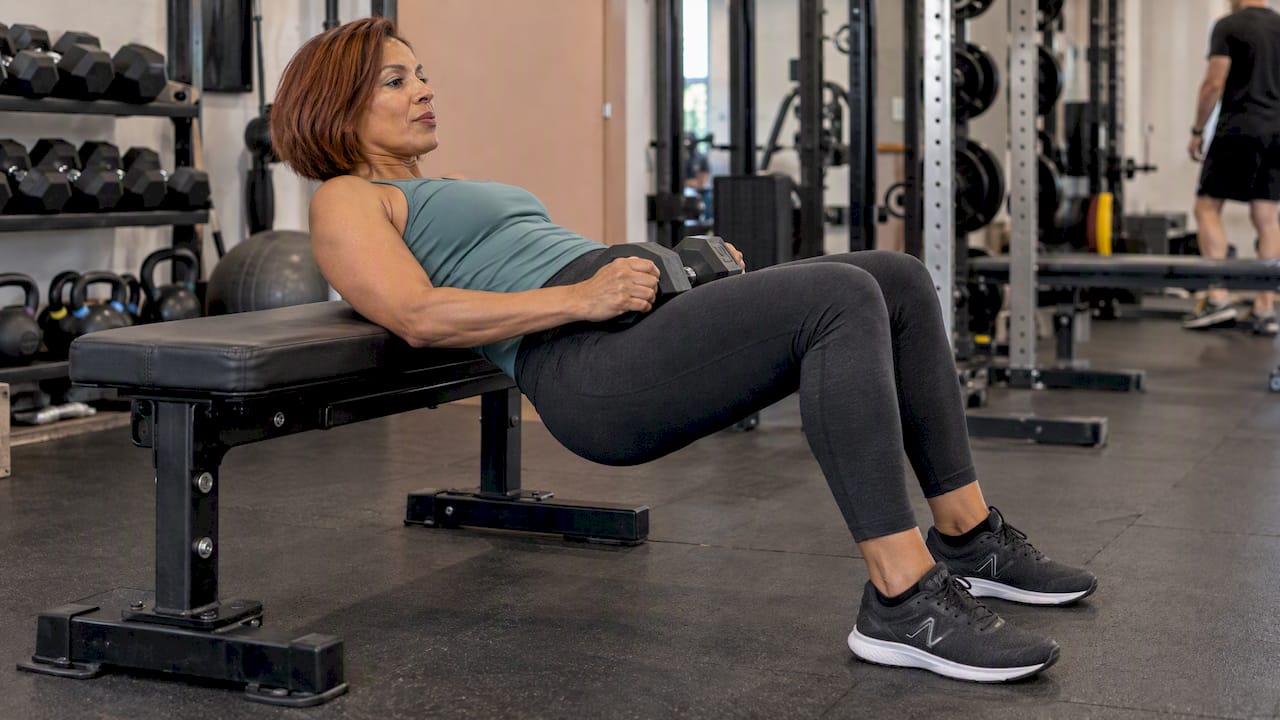 Woman demonstrating a controlled bench hip thrust