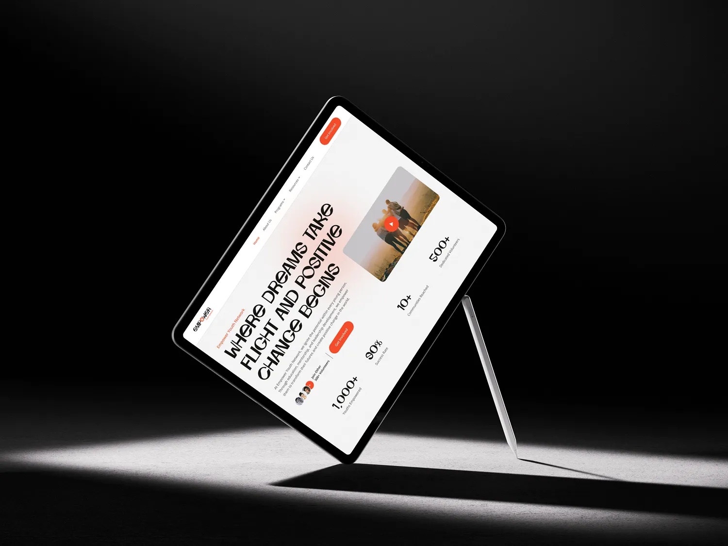 A digital tablet displaying a website with text and images, positioned on a stand. The background is dark, highlighting the tablet's screen content, which includes phrases about dreams and changes..