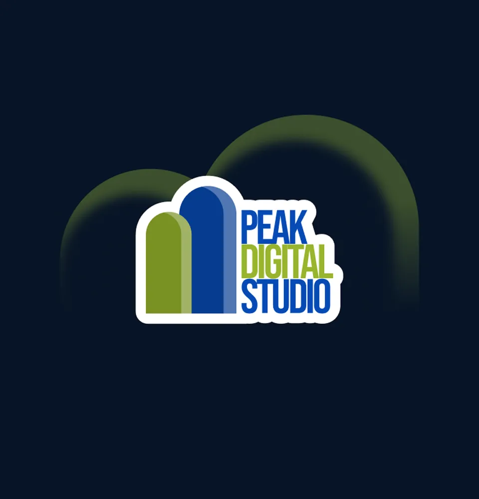 A workspace featuring a dual-monitor setup for coding and design, with an iPad, phone, coffee, and a plant.