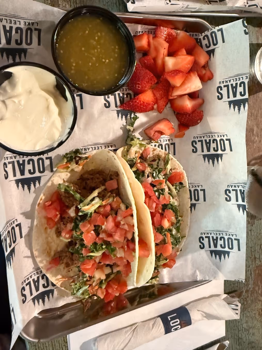 2 tacos with strawberries and salsa on the side