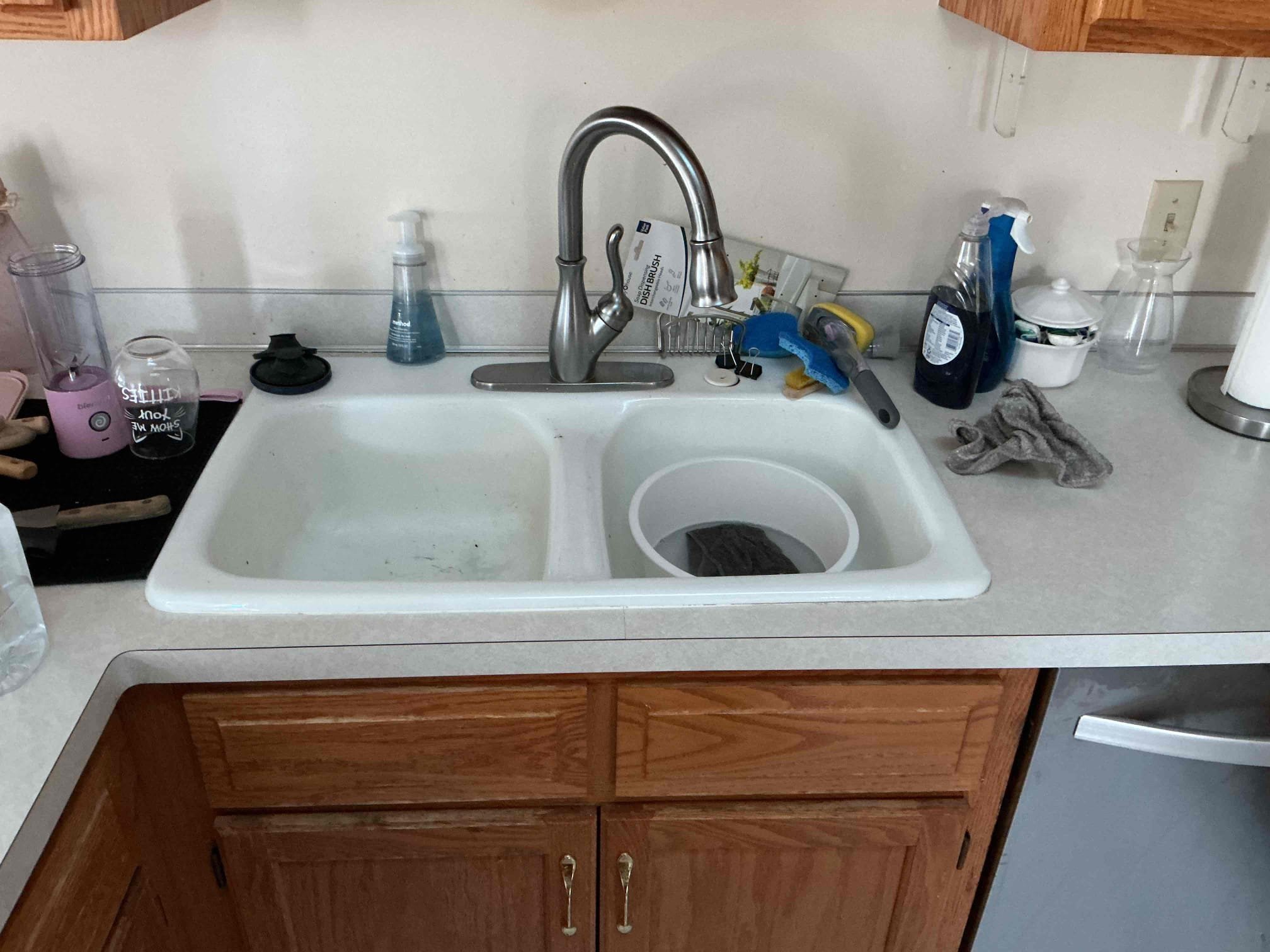 Outdated kitchen faucet and sink before replacement in Eagan Minnesota