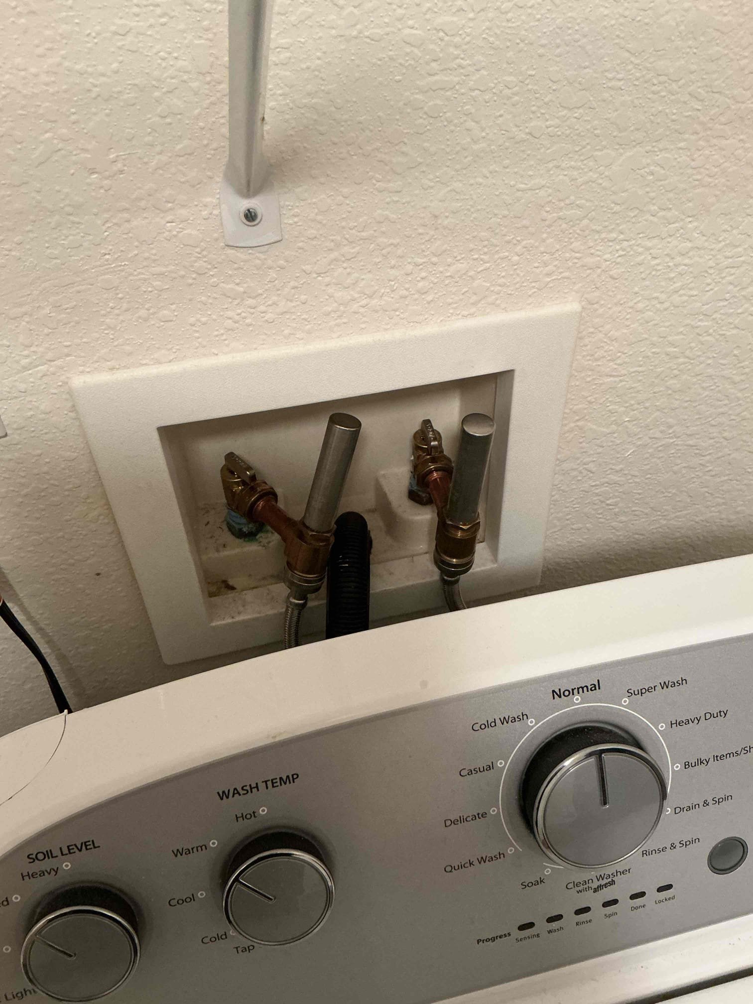 New Dahl boiler drains and water hammer arrestors installed in an Eagan apartment washer box with the washing machine reconnected