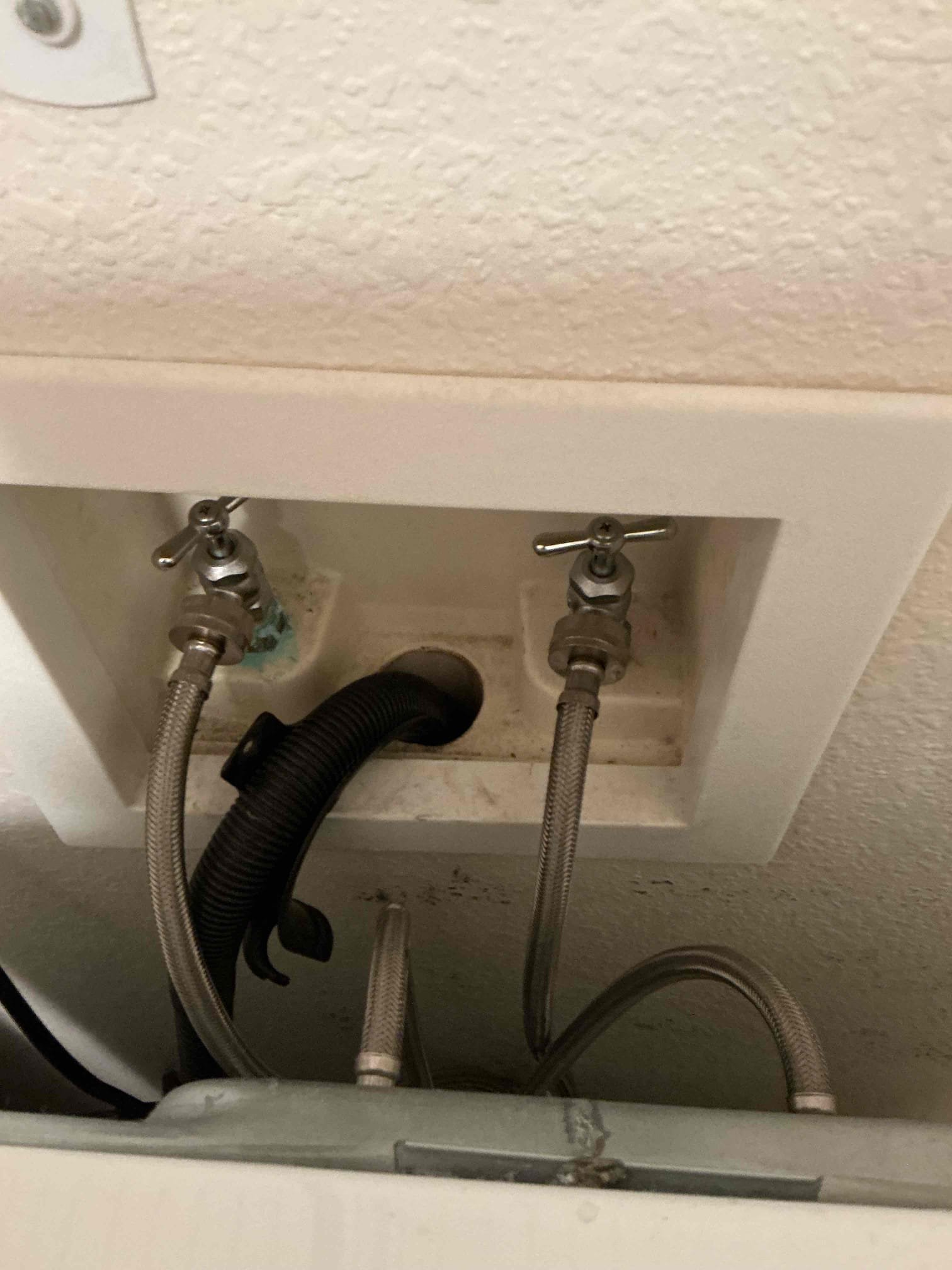 Leaking washer box shut-off valves in an Eagan apartment unit before replacement