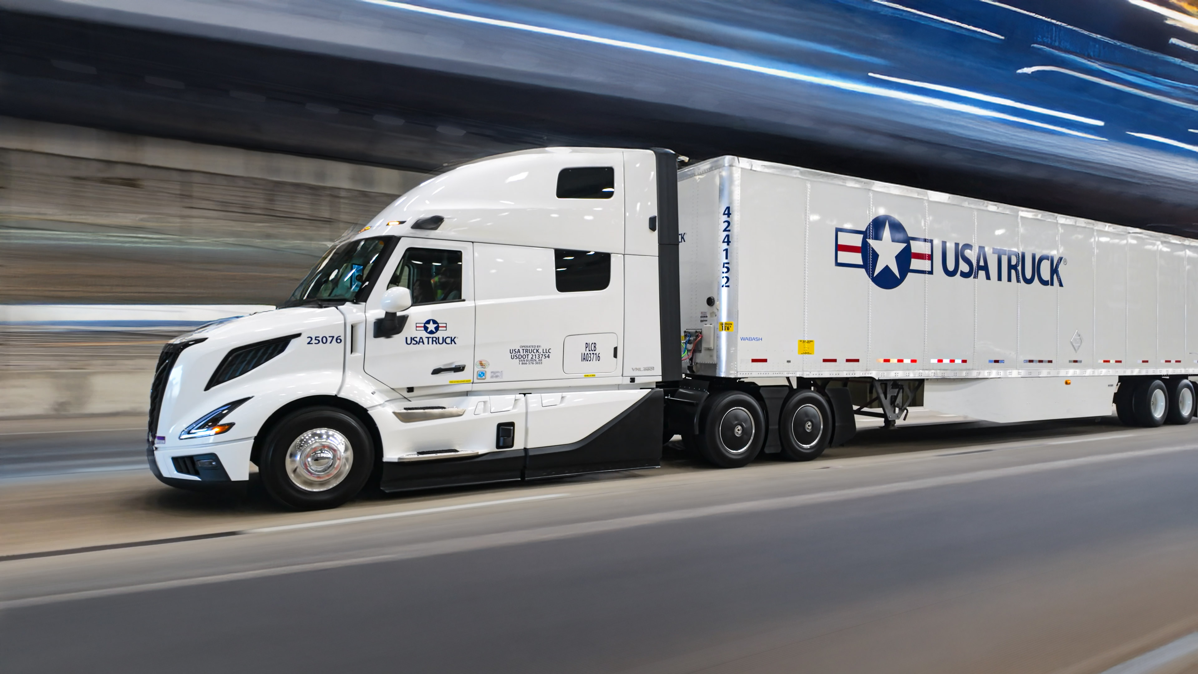 semi truck driving down the road