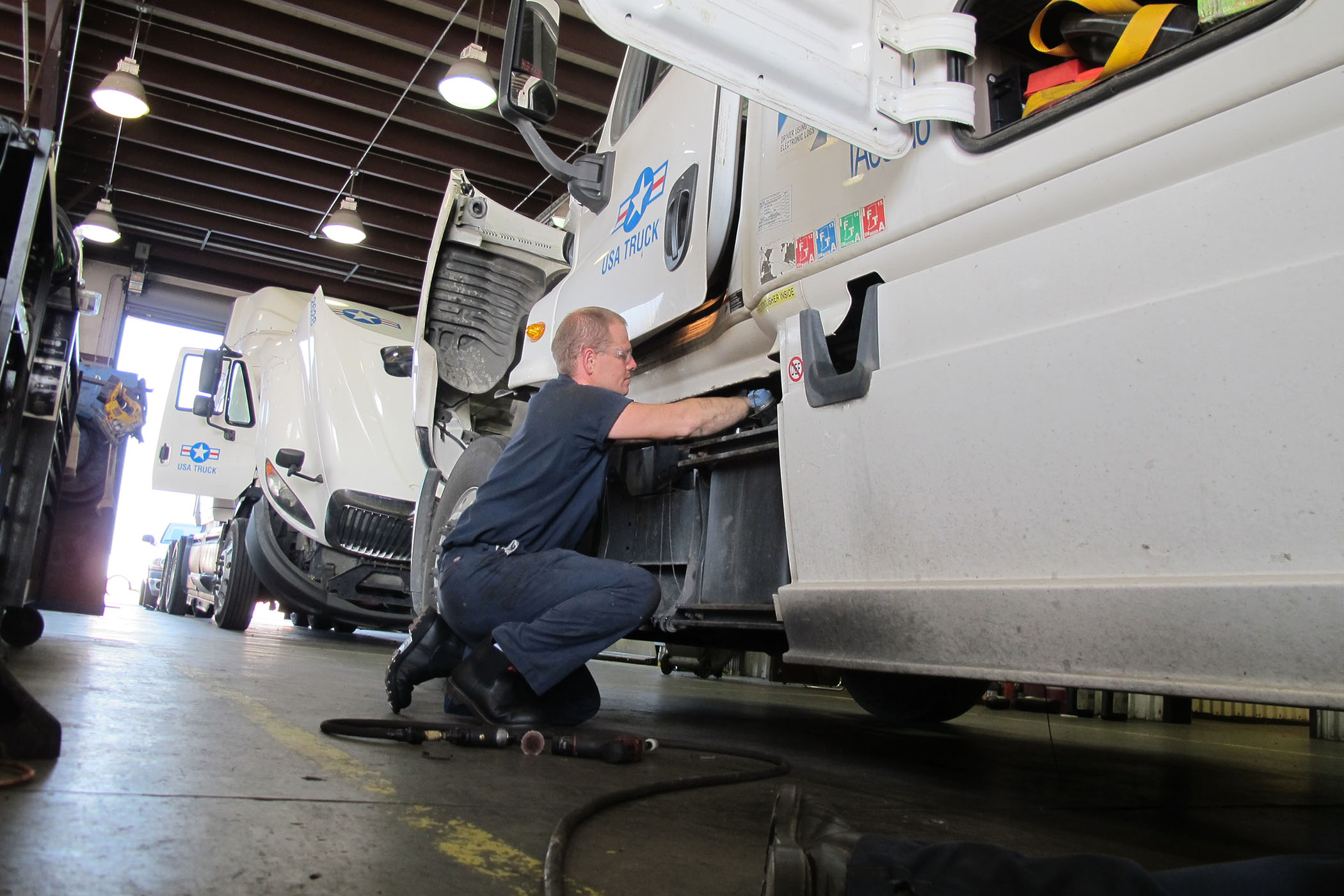 diesel technician working on semi truck