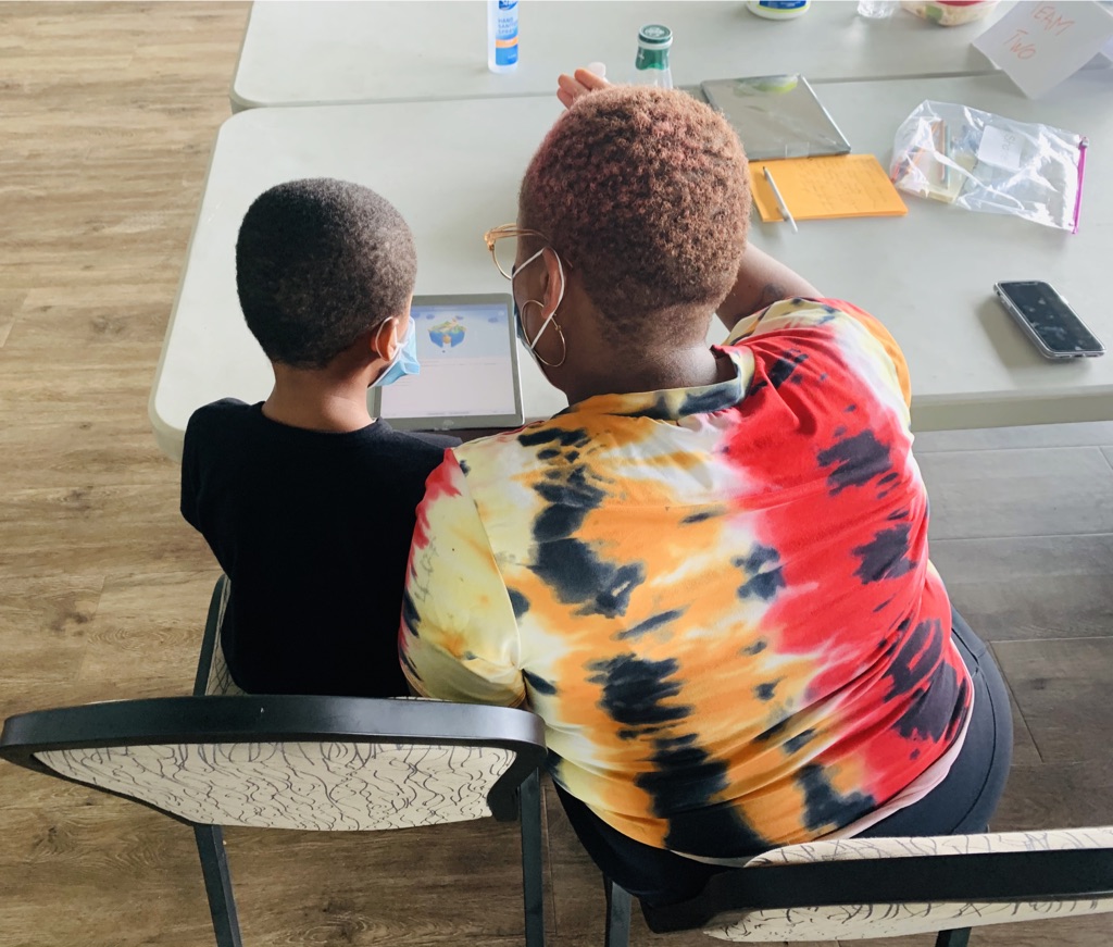 A women and young child looking at an ipad
