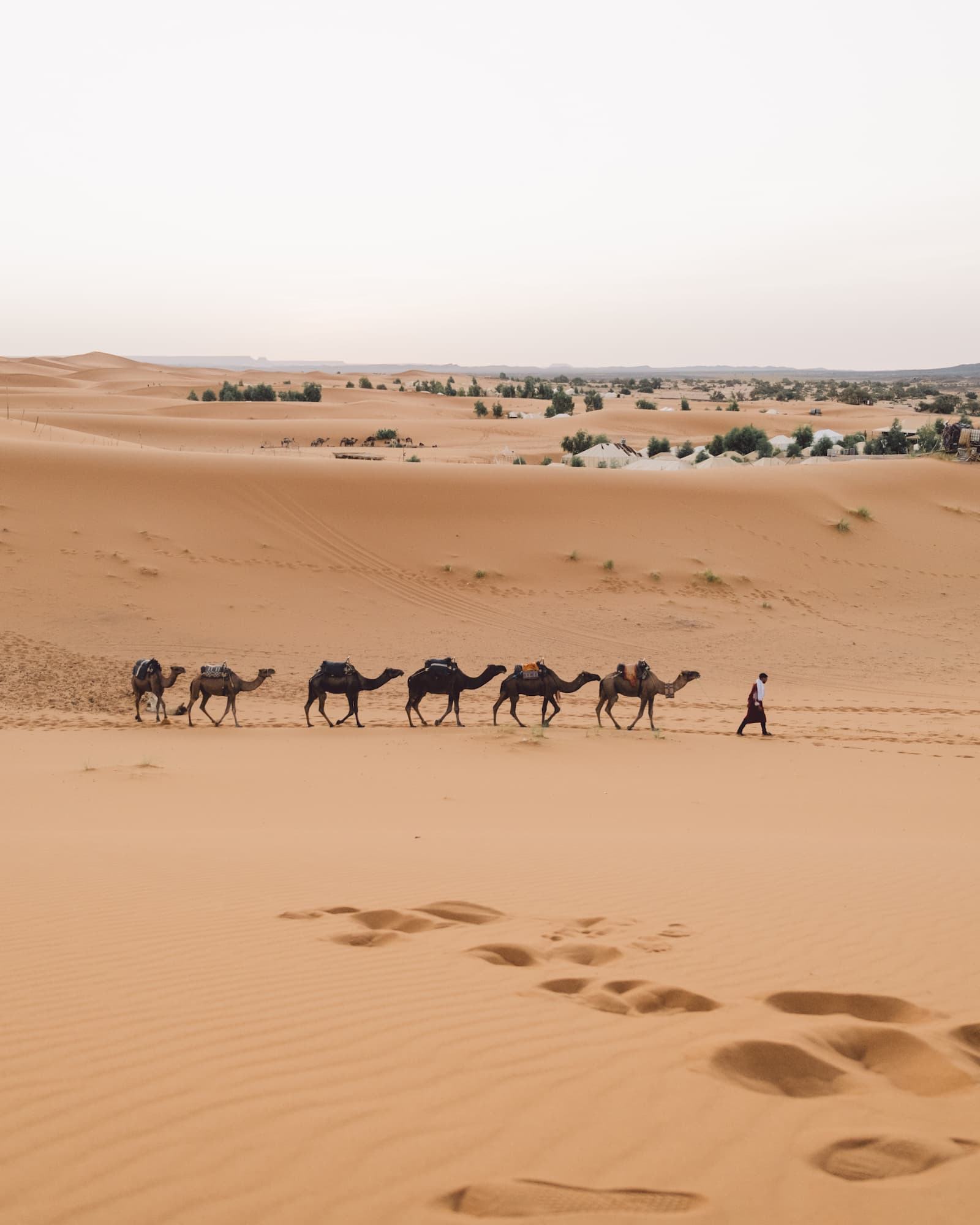 A Moroccan seller standing in Aït Benhaddou valley during a South Morocco tour with Moroccan Guides Travel