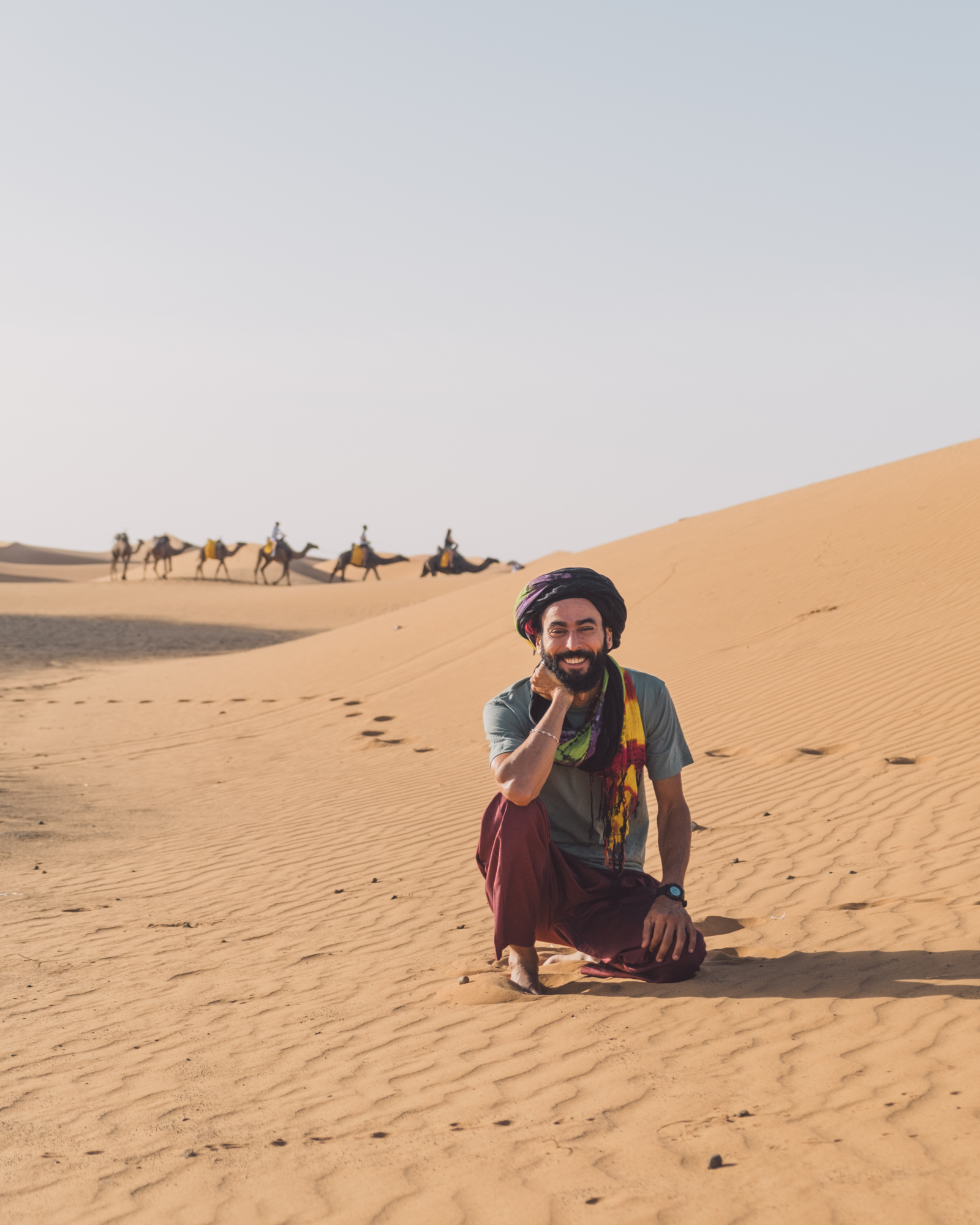A traveler photographing the ancient kasbah of Aït Ben Haddou on a phone