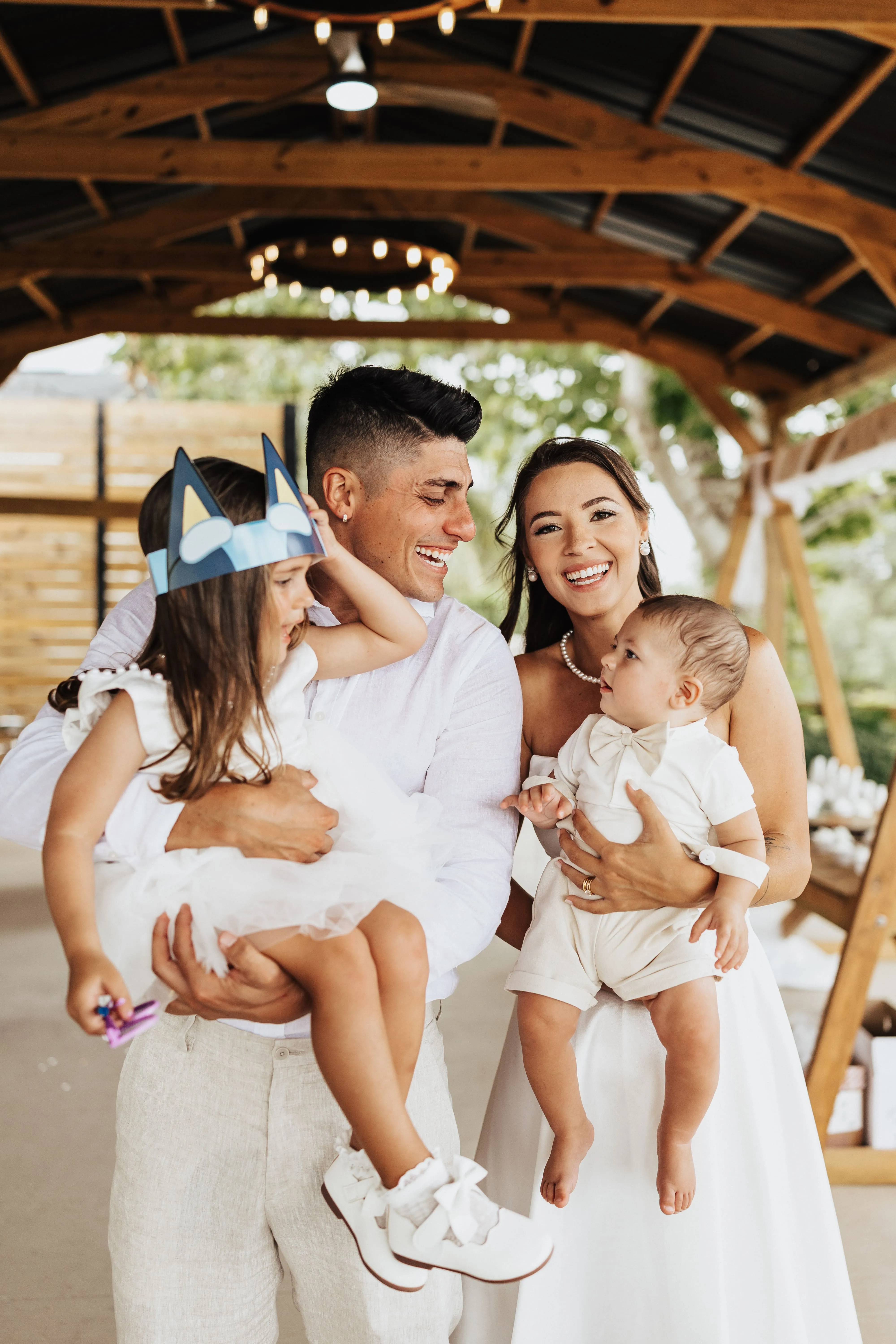 Lucas, founder of Allforliz, smiling with his wife and two children at an outdoor family event