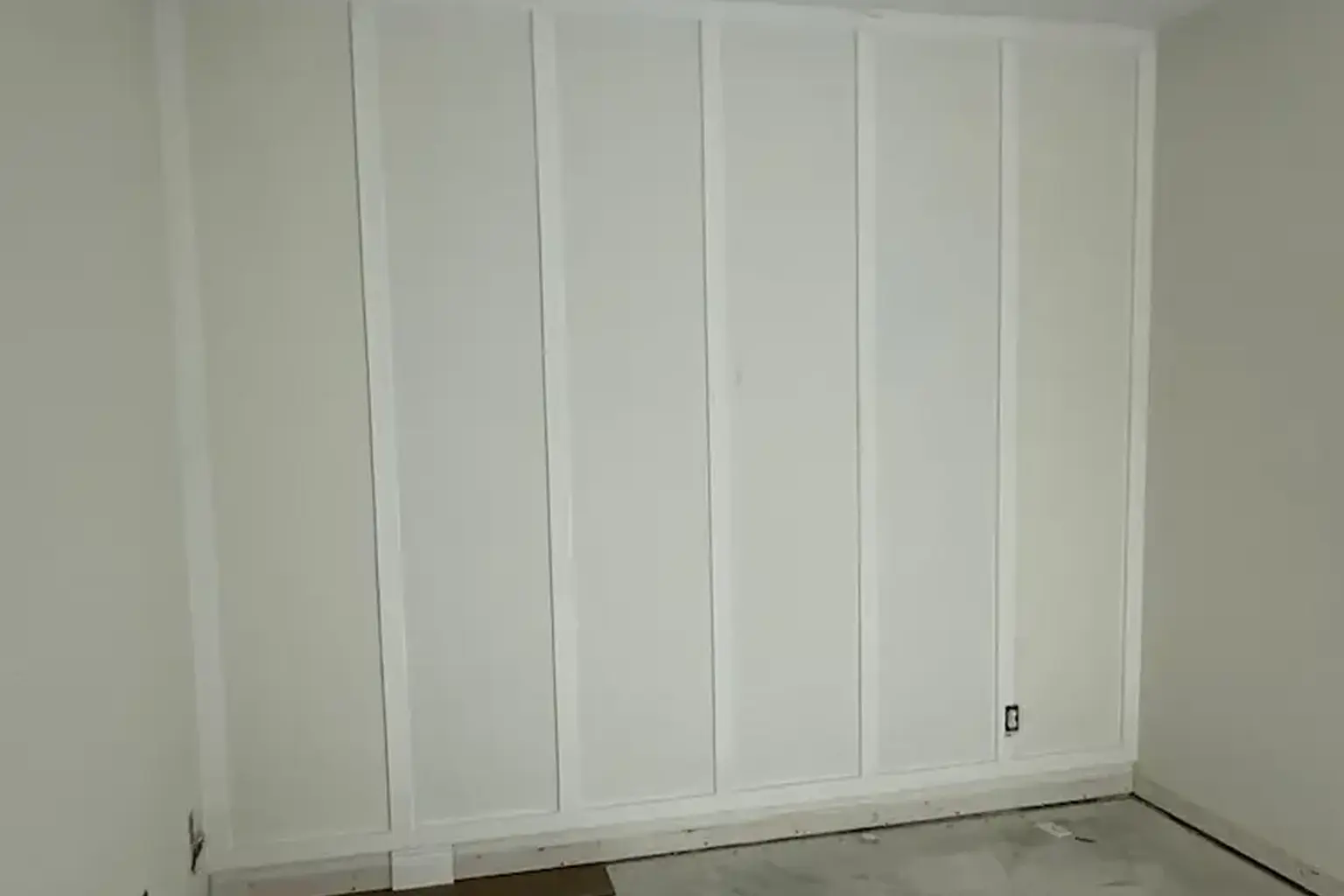 Living room before interior painting, showing older wall paint and dated look