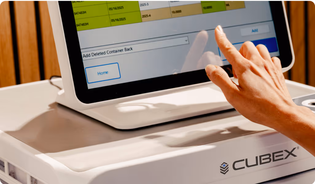Photo of a a vet tech touching the CUBEX touchscreen installed with a CUBEX mini cabinet 