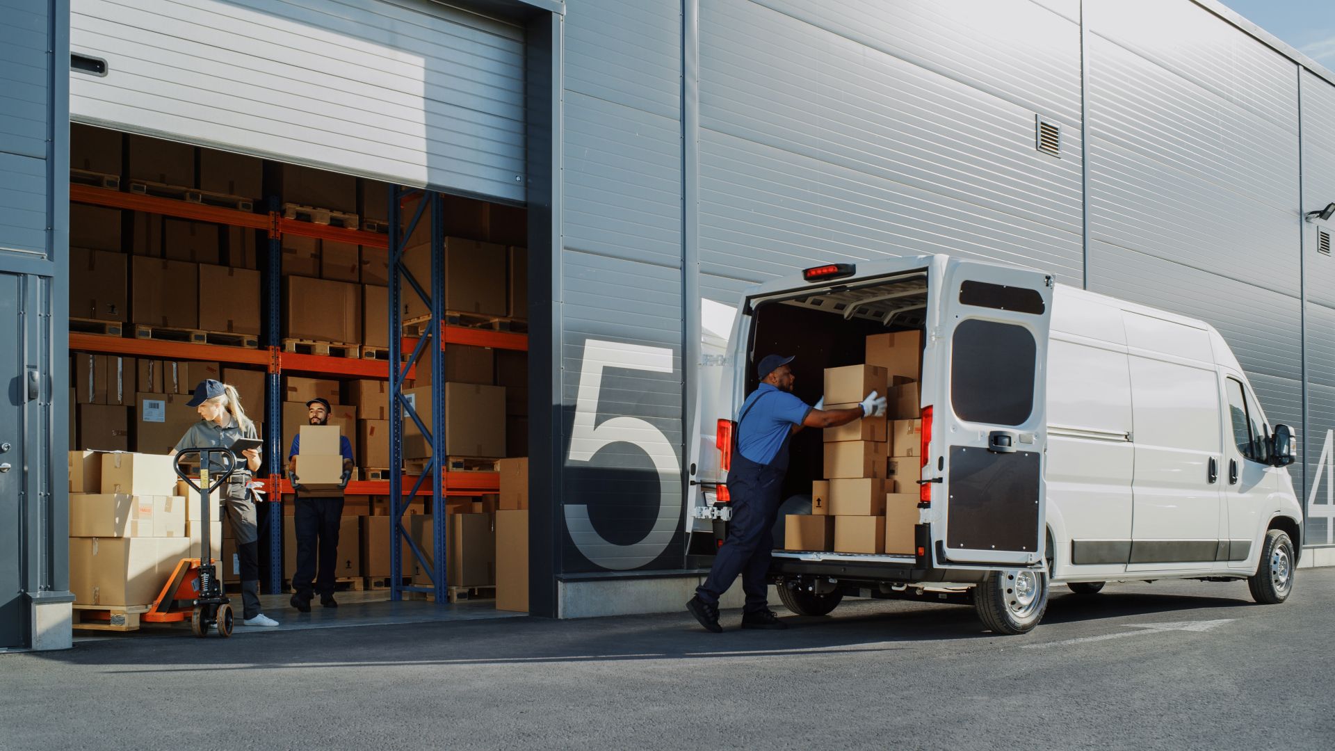 A van with boxes that are being unloaded