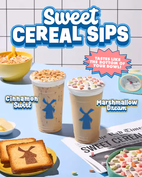 Two iced drinks styled with cereal toppings—one with cinnamon crumble, the other with colorful marshmallow charms—surrounded by bowls, toast, and playful props for nostalgic breakfast-themed beverage photography.