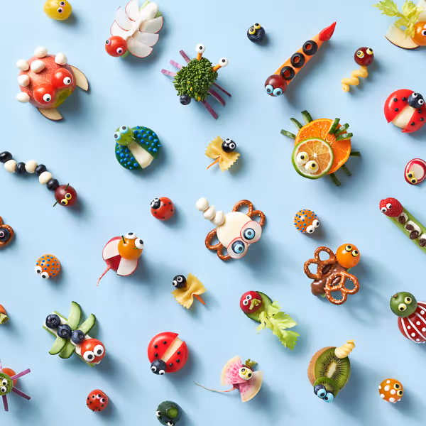Photograph of food arranged in a repeating pattern, captured from a flat lay perspective, showcasing tiny edible creatures.