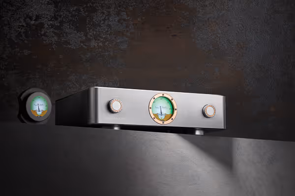 Audio photography of a sleek, modern amplifier with illuminated dials and knobs, set against a textured dark background with dramatic lighting.