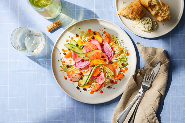 Artfuly prepared citrus salad food photography on a styled set.