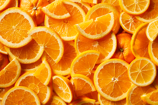 Vibrant food photography of fresh orange slices, capturing their juicy texture and bright color in a detailed close-up shot.
